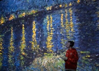 A visitor-facing immersive gallery scene with Van Gogh artwork projected across the walls at Frameless