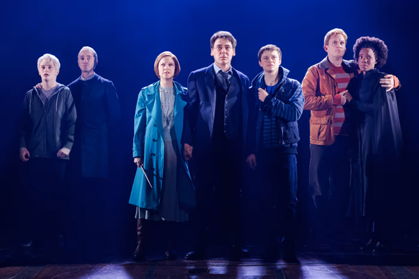 Harry Potter and the Cursed Child ensemble in a blue-lit final tableau