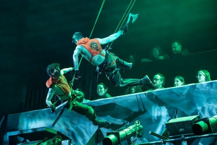 Actors performing in a dramatic Hunger Games on Stage scene