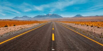 A desert highway running through mountains