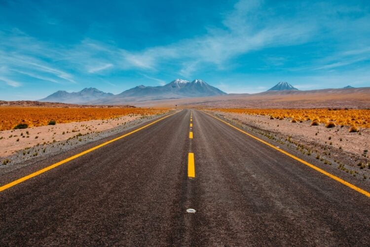 A desert highway running through mountains