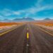 A desert highway running through mountains