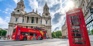 Bright red City Sightseeing bus touring London