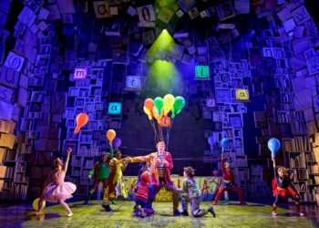 Matilda and the cast performing on the Cambridge Theatre stage
