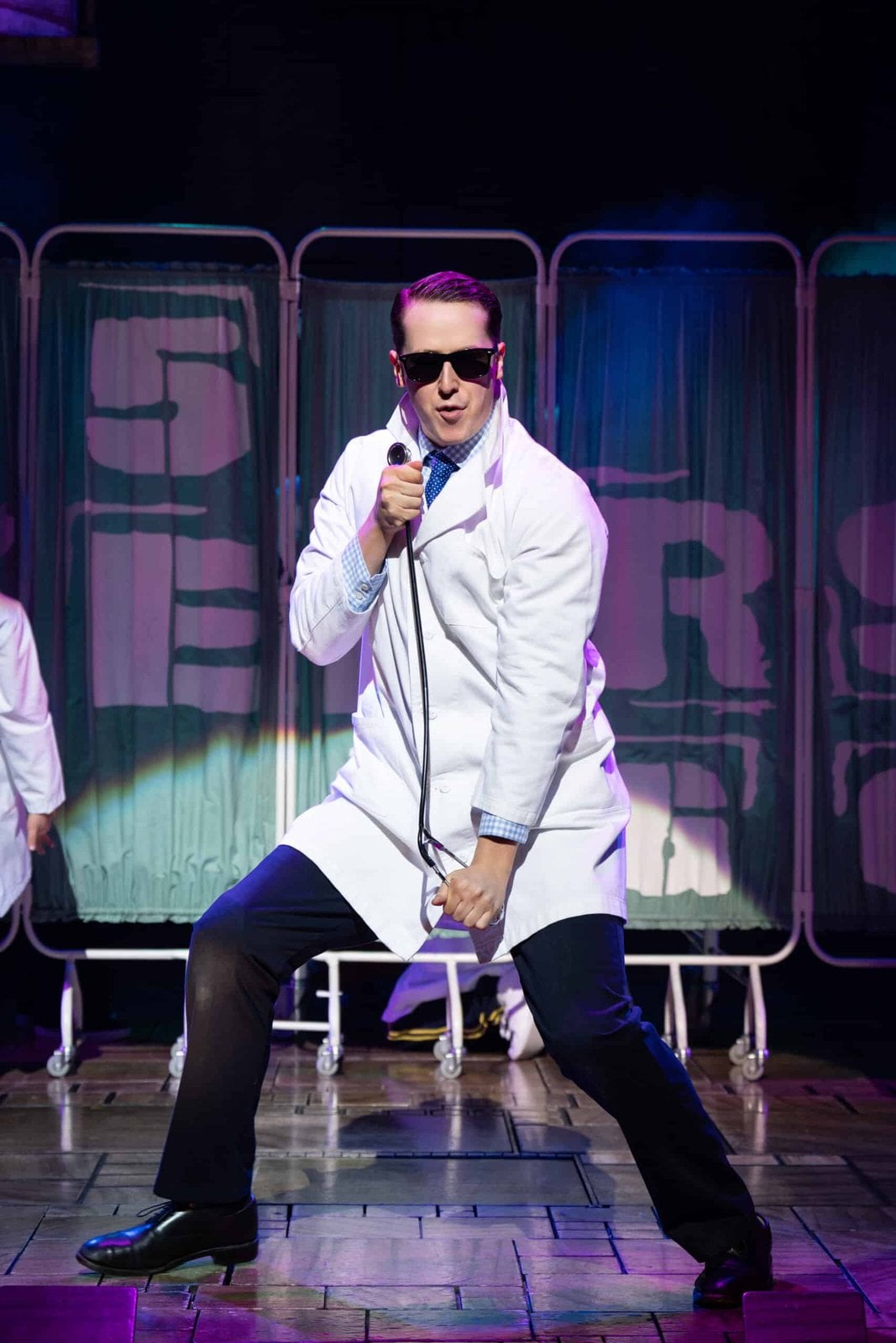 Doctor singing on stage in Matilda The Musical