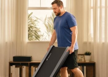 Person storing the Merach UltraWalk W60 Plus walking pad in a home
