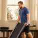Person storing the Merach UltraWalk W60 Plus walking pad in a home