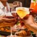 Guests toasting cocktails at dinner