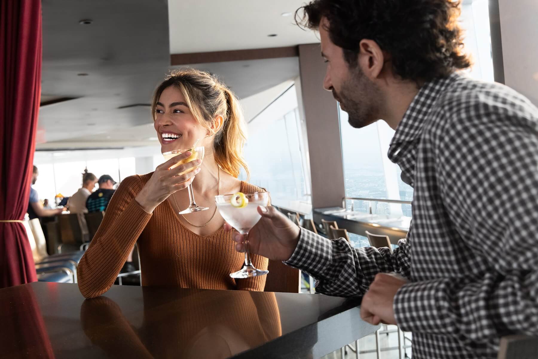 Couple dining with daytime skyline views at ONE Dine