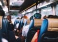 Passengers seated inside an airport transfer bus