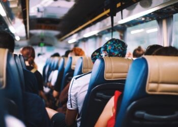 Passengers seated inside an airport transfer bus