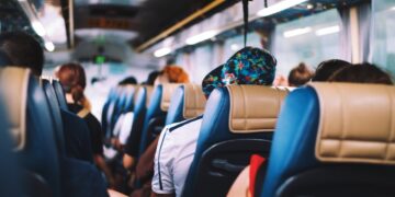 Passengers seated inside an airport transfer bus