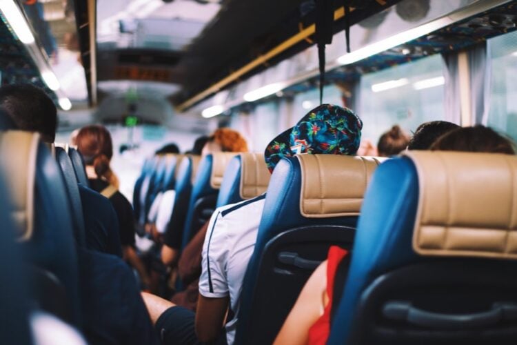 Passengers seated inside an airport transfer bus