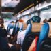 Passengers seated inside an airport transfer bus
