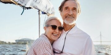 Mature couple enjoying a sailing trip while considering heart condition cover
