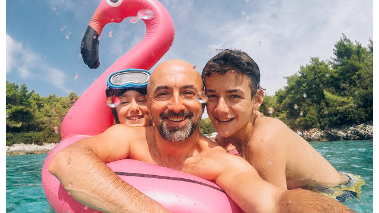 Family swimming with an inflatable flamingo