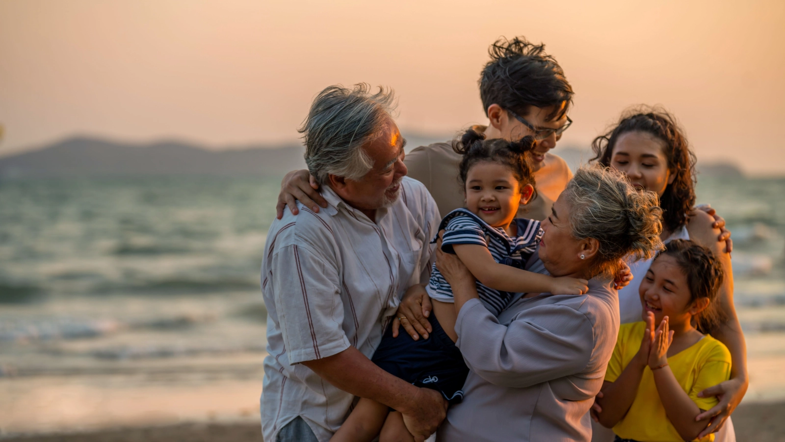 Family gathered together at a beach