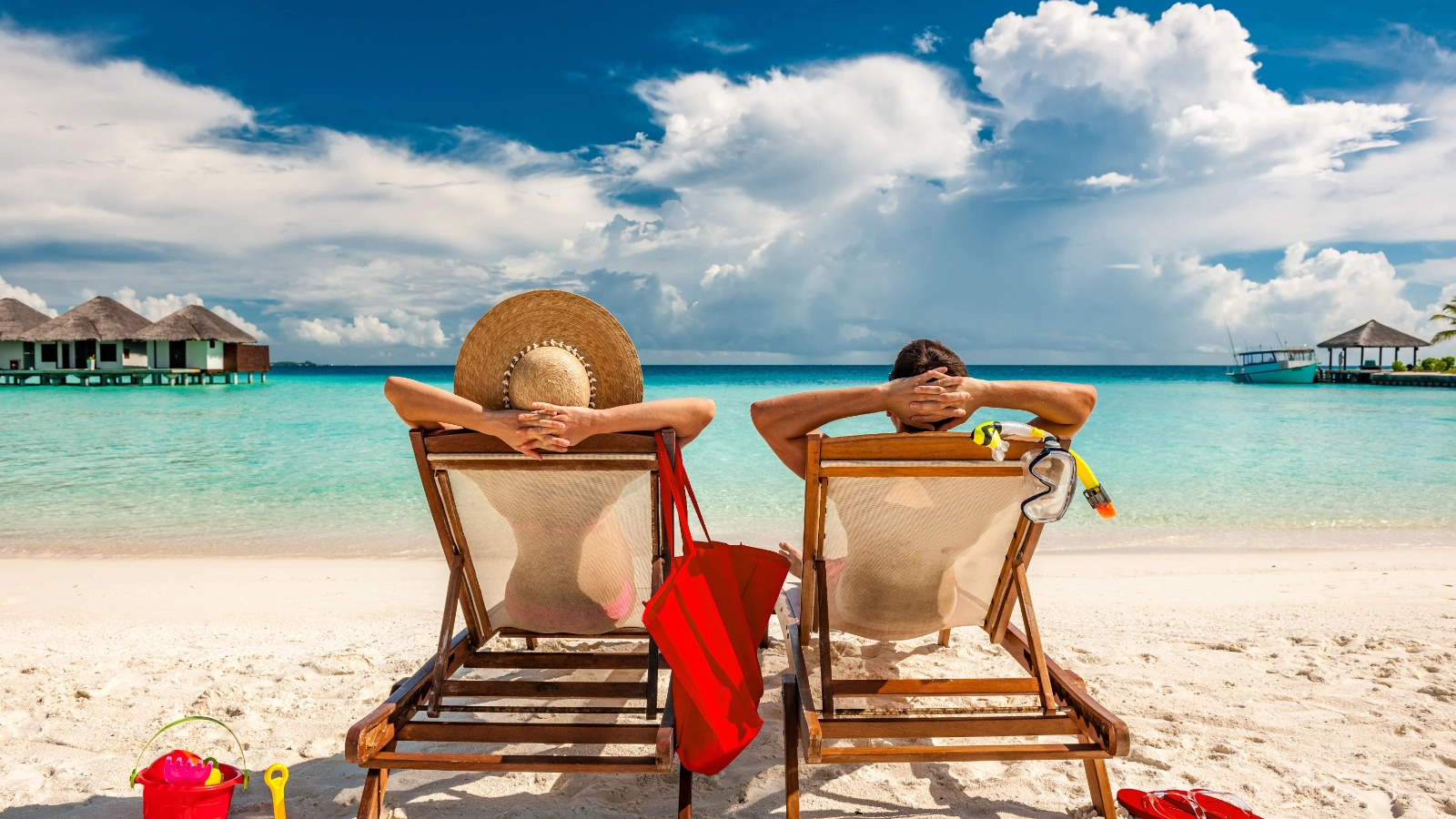 Two travellers relaxing on a tropical beach