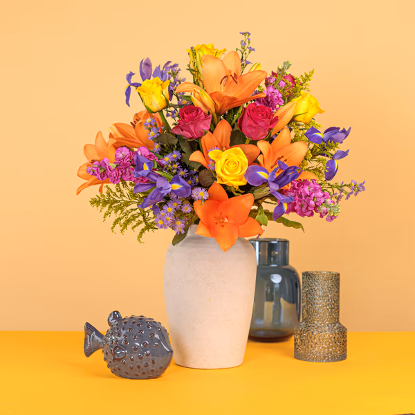 Detail of colourful lilies roses and seasonal flowers