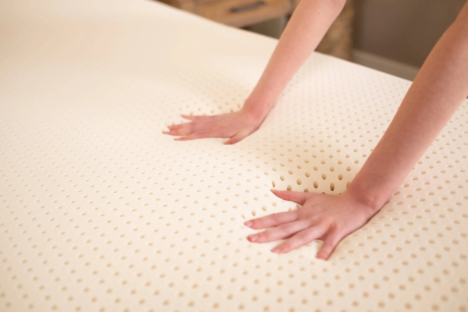 Natural latex mattress topper on a bed