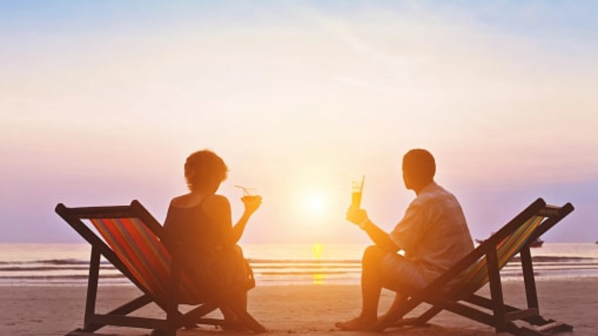 Couple sitting on beach deckchairs
