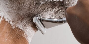 Person shaving with a razor