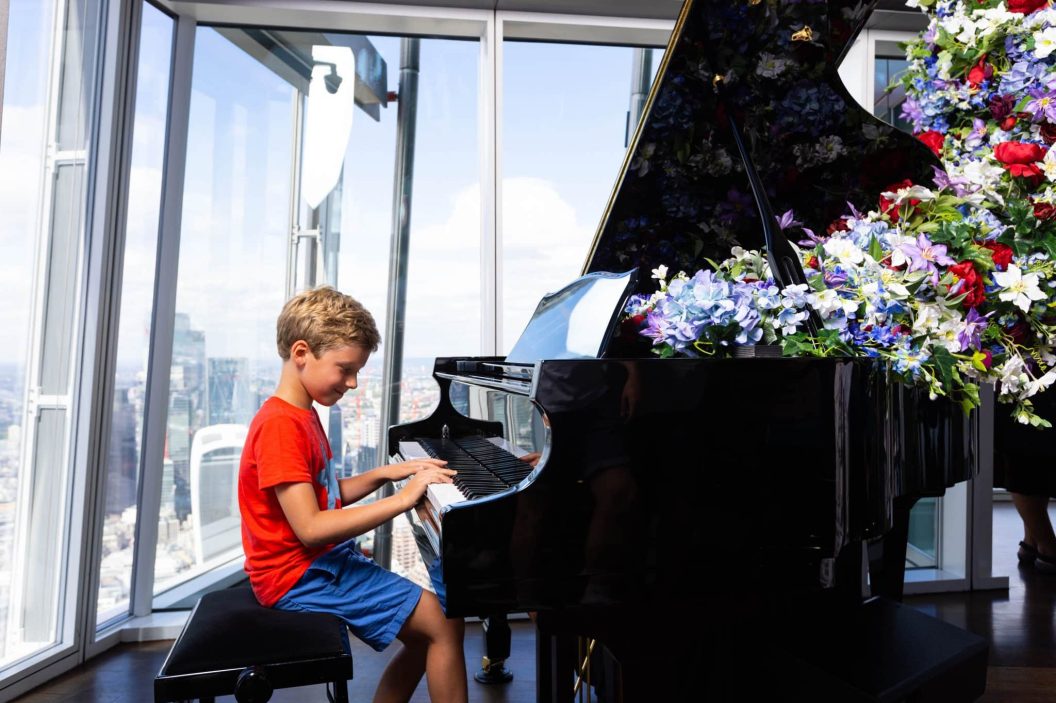 A boy playing piano at The View from The Shard