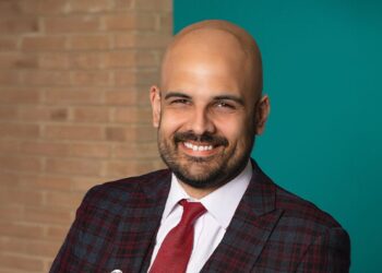 A smiling man in a suit