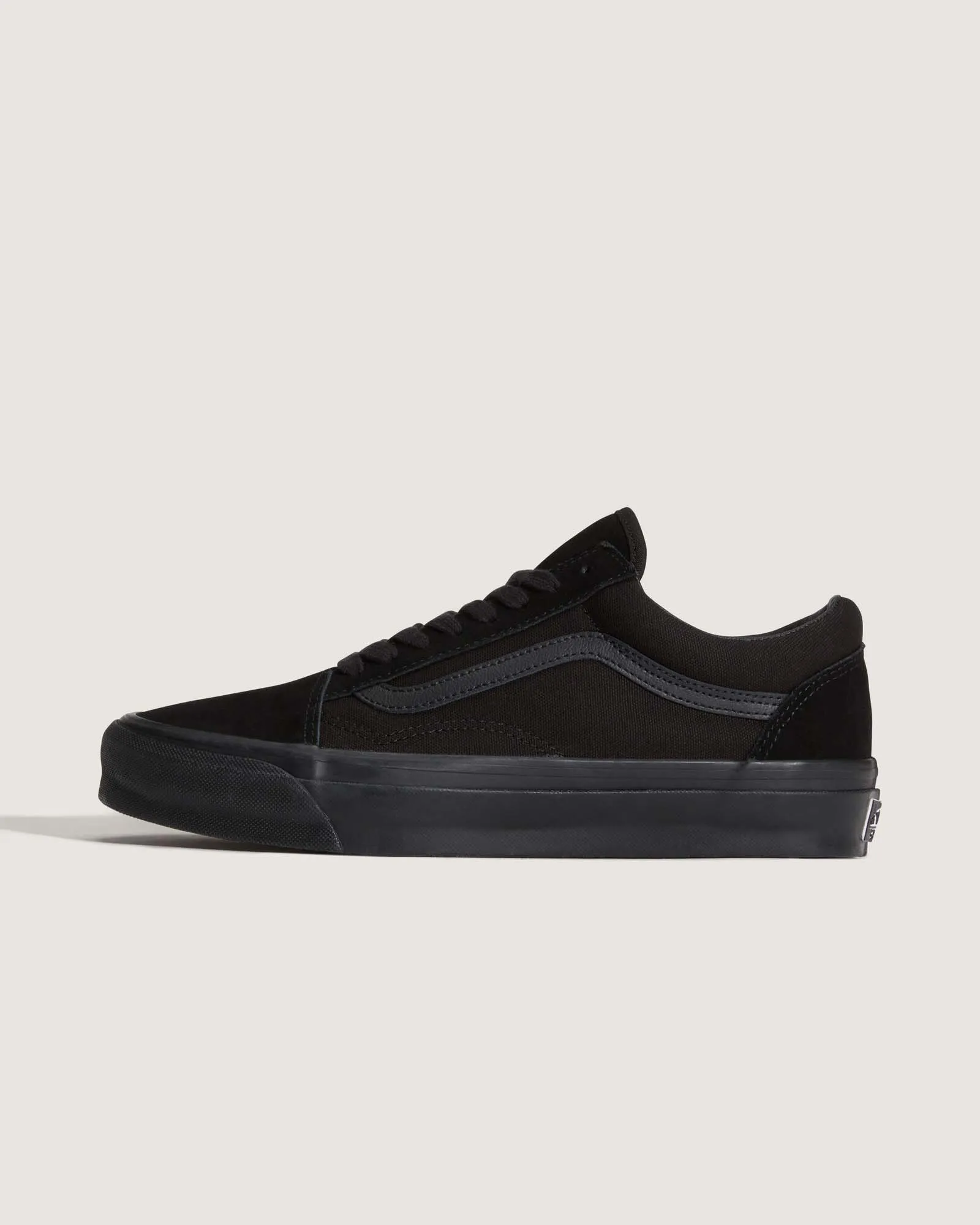 Black Vans Old Skool shoe shown from the side