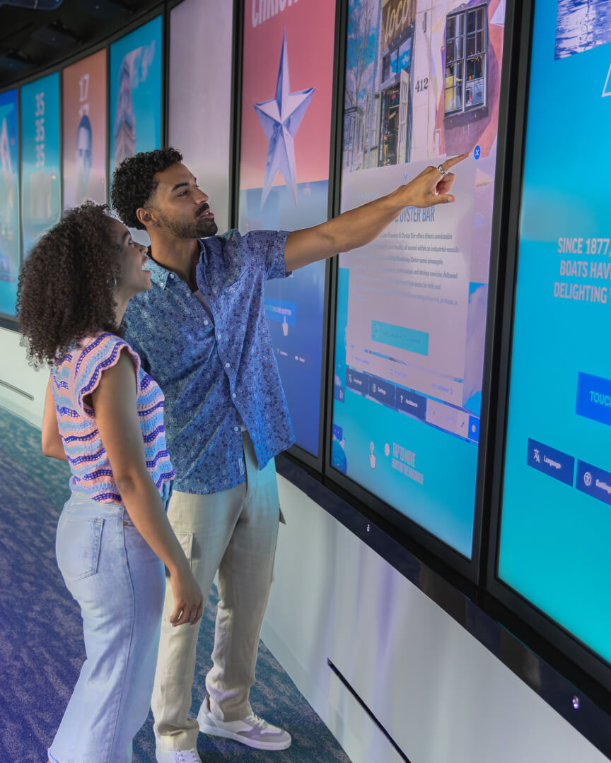 Visitors exploring an interactive gallery at View Boston