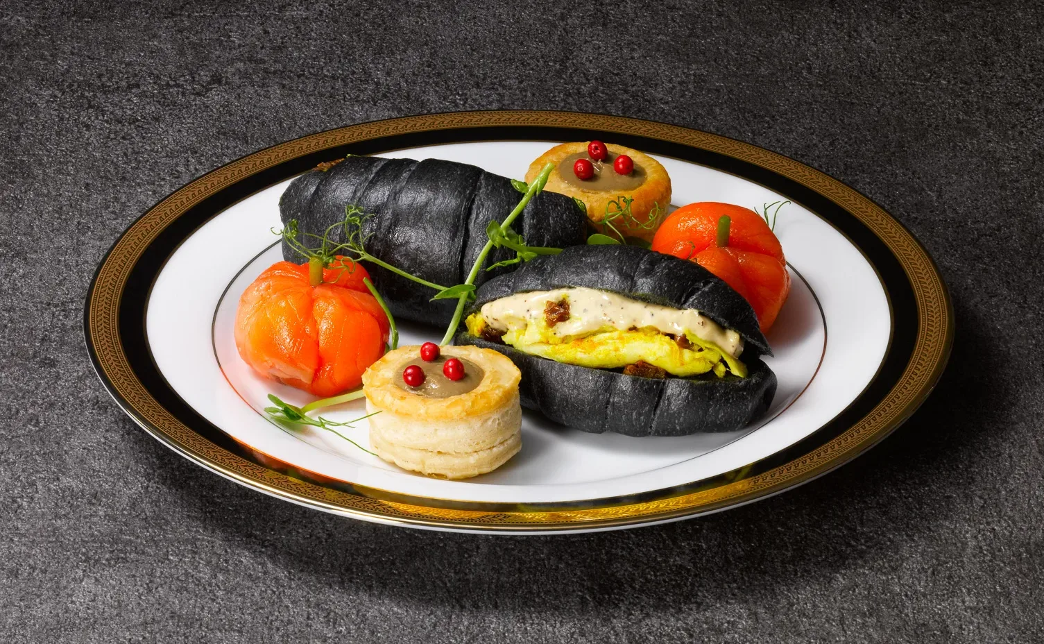 Sandwiches and savoury bites on the bottom plate of the high tea