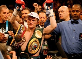 Boxer celebrating with championship belts in a Zapply campaign image