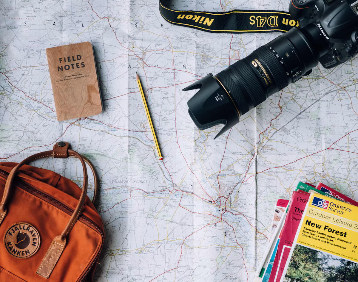 Map and travel gear arranged for trip planning