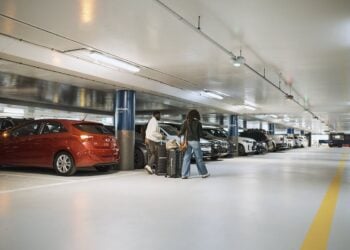 Airport parking garage with rows of parked vehicles