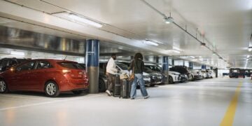 Airport parking garage with rows of parked vehicles