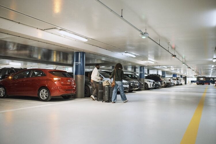 Airport parking garage with rows of parked vehicles