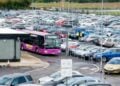 Airport parking shuttle moving through a car park