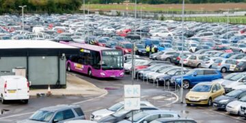 Airport parking shuttle moving through a car park
