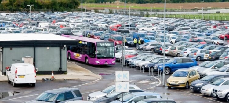 Airport parking shuttle moving through a car park
