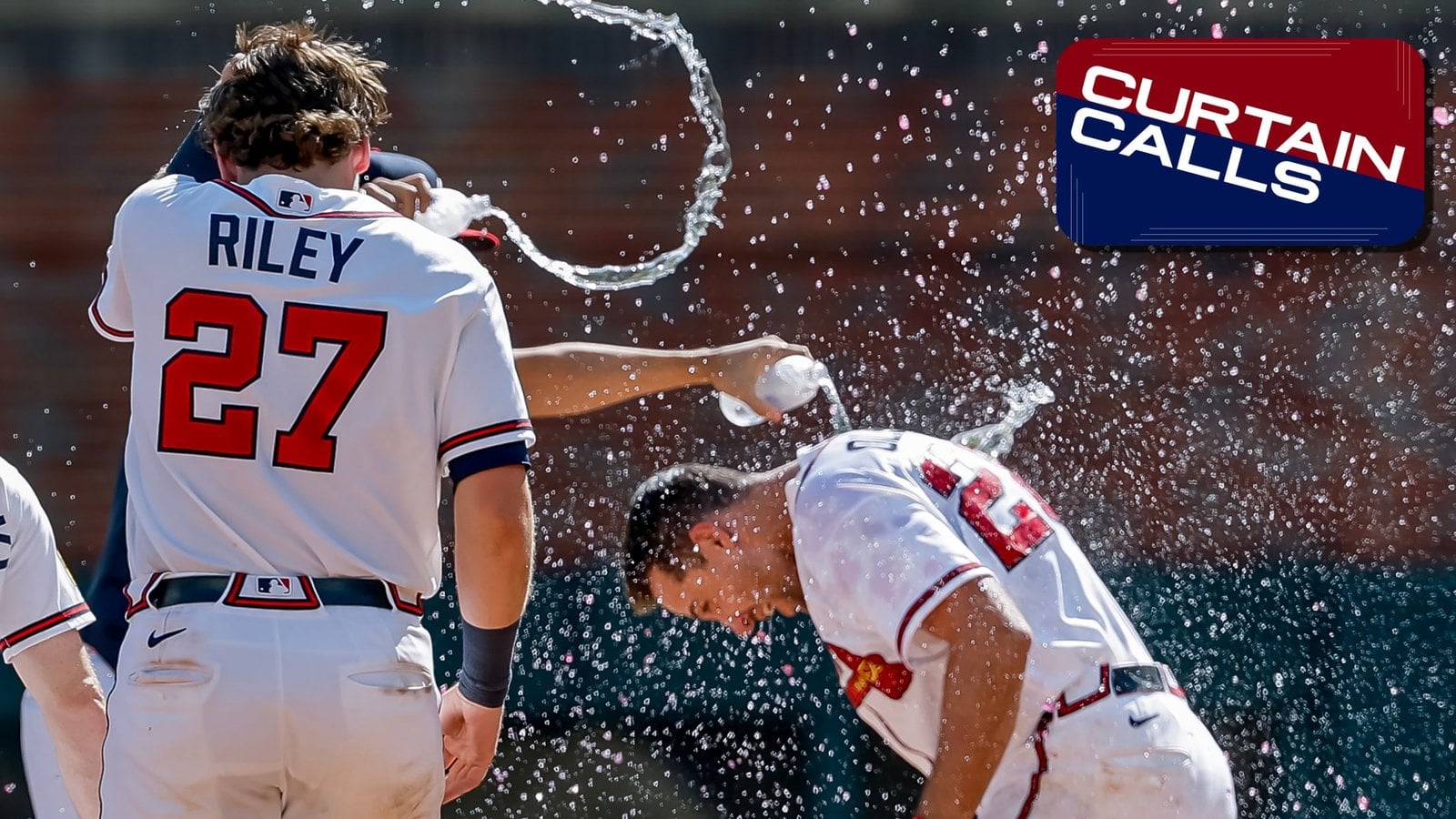 Atlanta Braves players celebrating with water after a game
