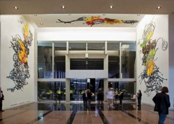 Visitors walking through an art-filled interior at AT&T Stadium
