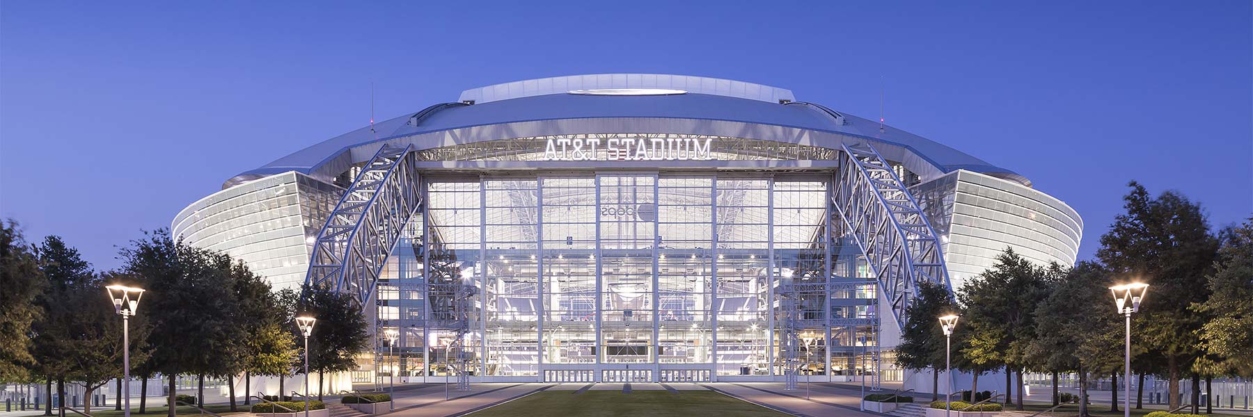 AT&T Stadium exterior illuminated in the evening