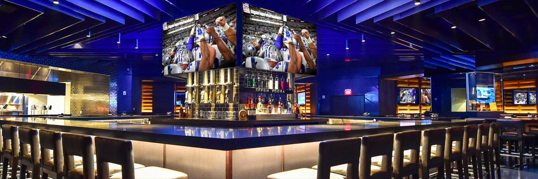 Club lounge interior with screens and seating at AT&T Stadium