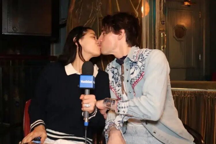 Two people kissing with a microphone
