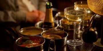 Food and drinks arranged on a table at the Kit Kat Club