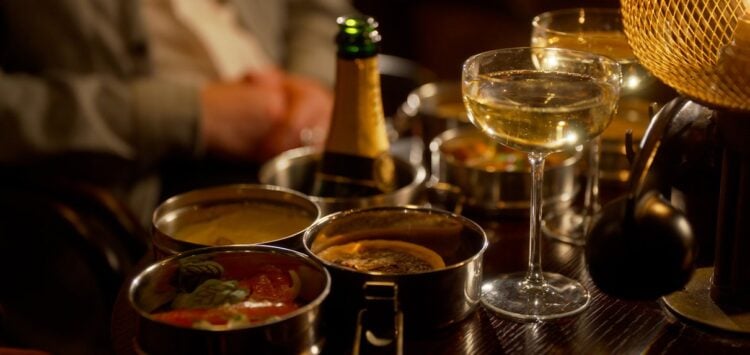 Food and drinks arranged on a table at the Kit Kat Club