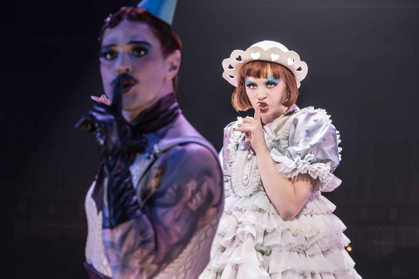 Cabaret performers and club setting in a vivid stage scene