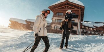 Skiers on a snowy Alpine slope at a Club Med resort