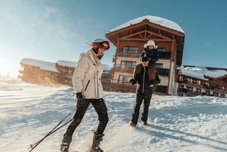 Skiers on a snowy Alpine slope at a Club Med resort