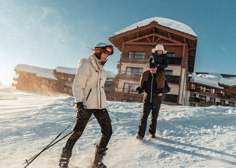 Skiers on a snowy Alpine slope at a Club Med resort